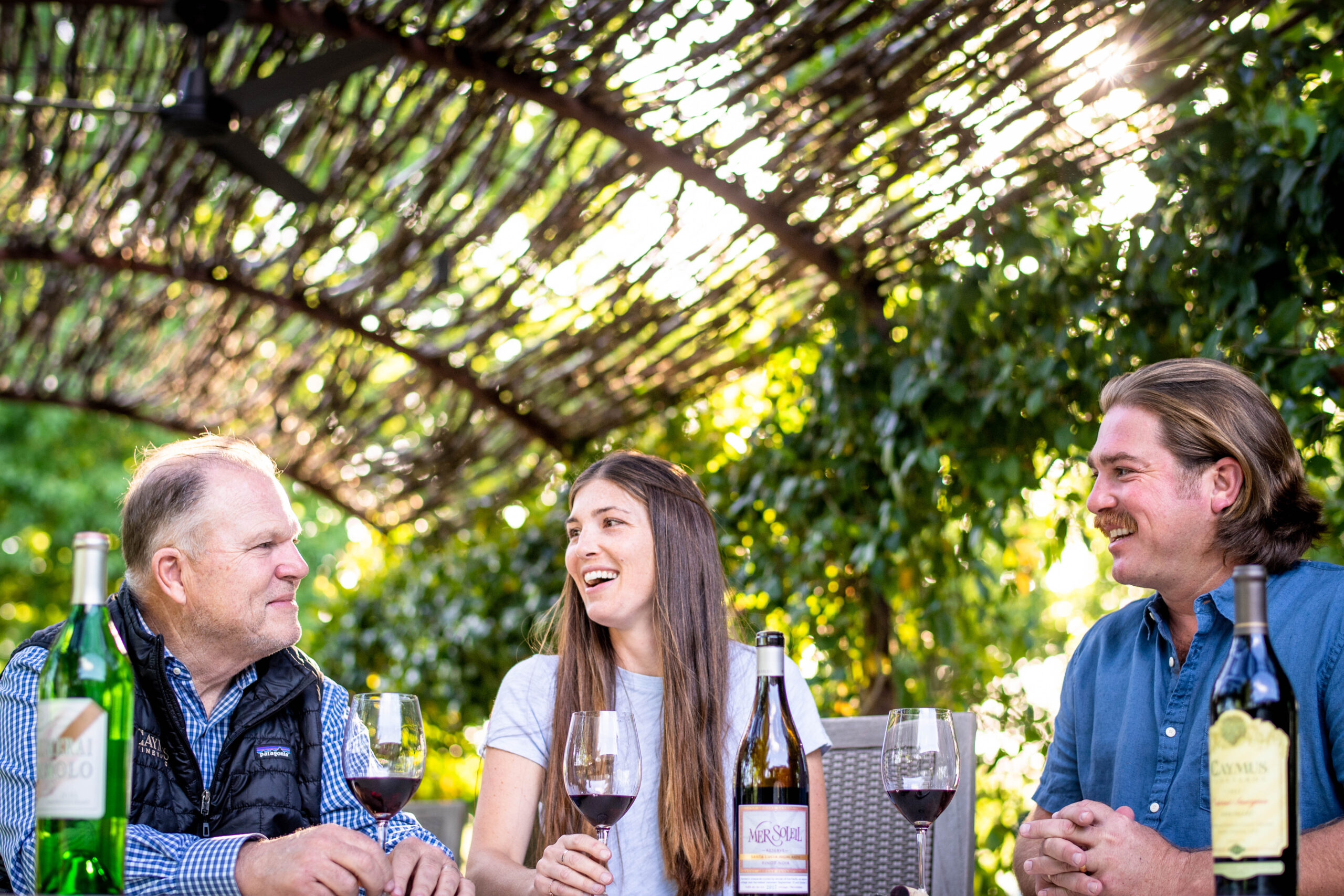 Chuck, Charlie, and Jenny Wagner sharing wine